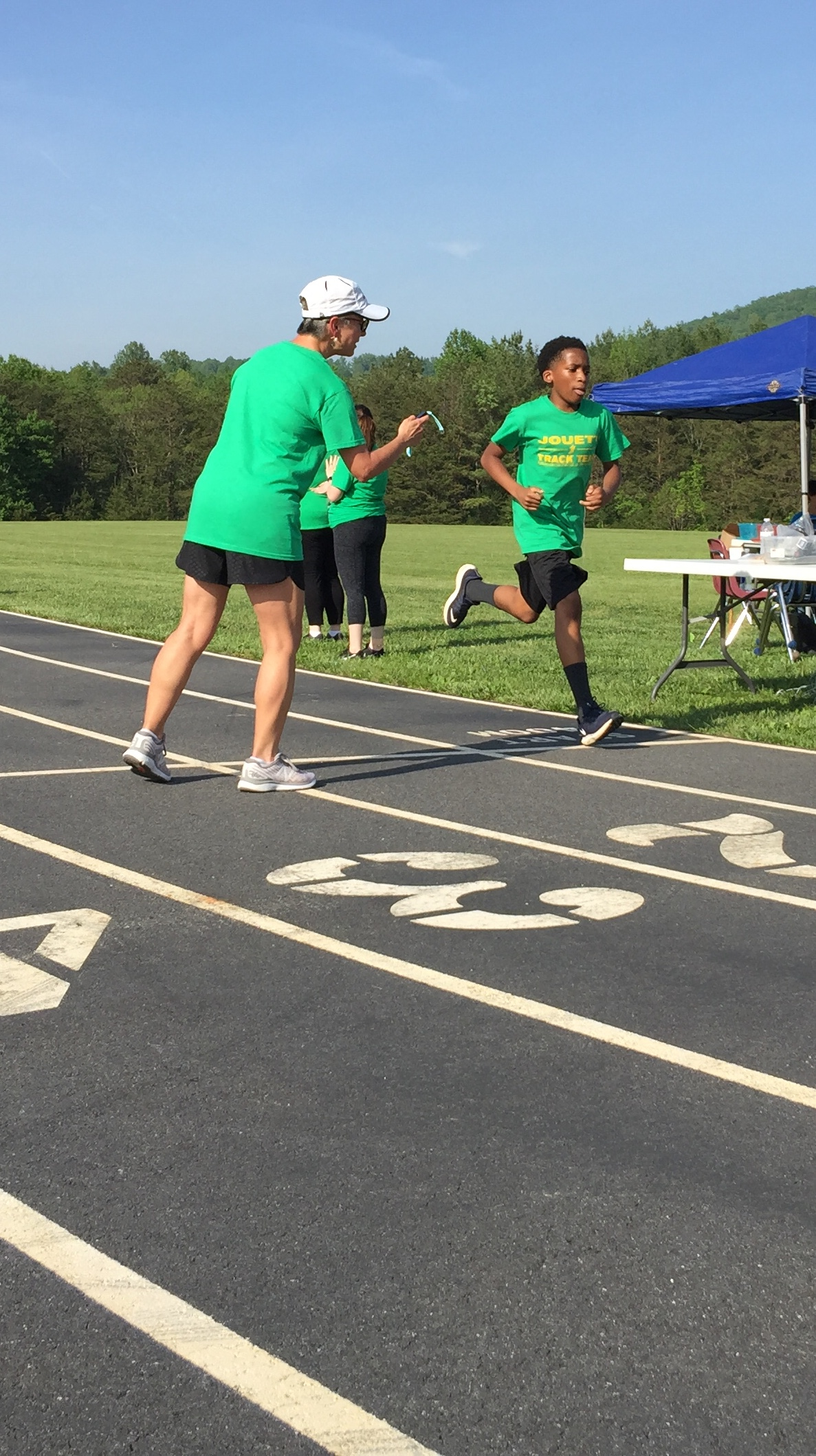 athlete and coach on outdoor track